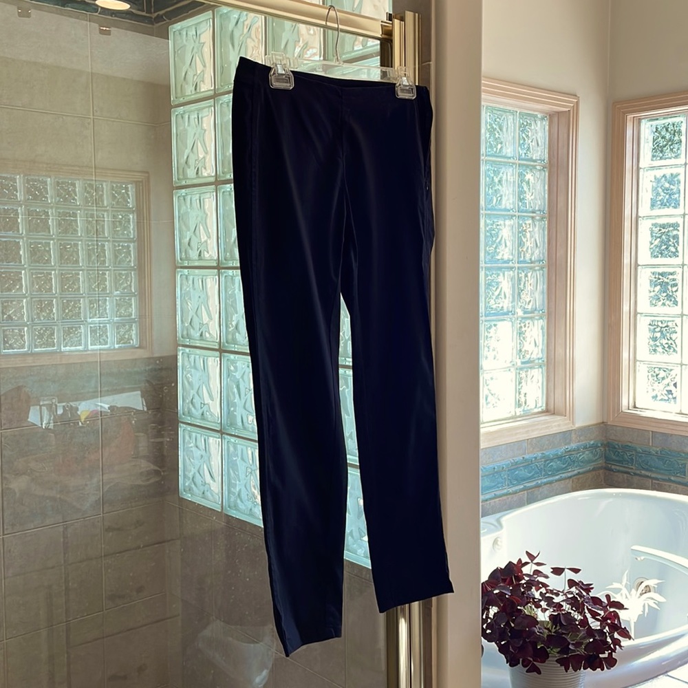 Stretchy black pants; tulip slit@bottom; side zipper; no pockets